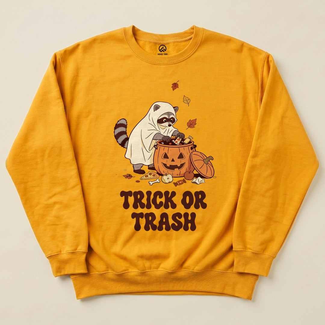 Gold Trick or Trash Sweatshirt with a raccoon in a ghost costume raiding a pumpkin candy bucket graphic