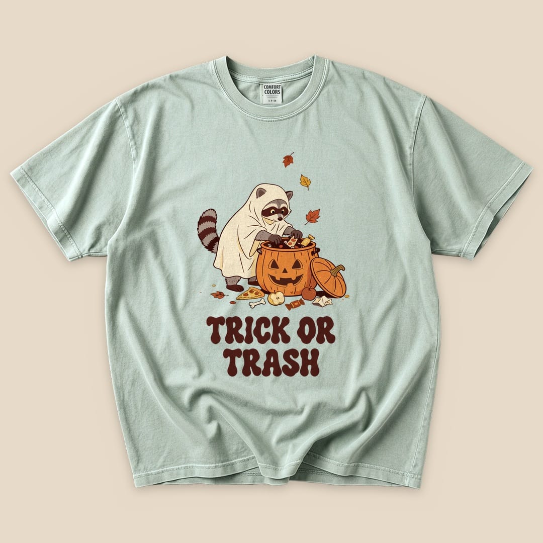 Bay Trick or Trash T-Shirt with a raccoon in a ghost costume raiding a pumpkin candy bucket graphic