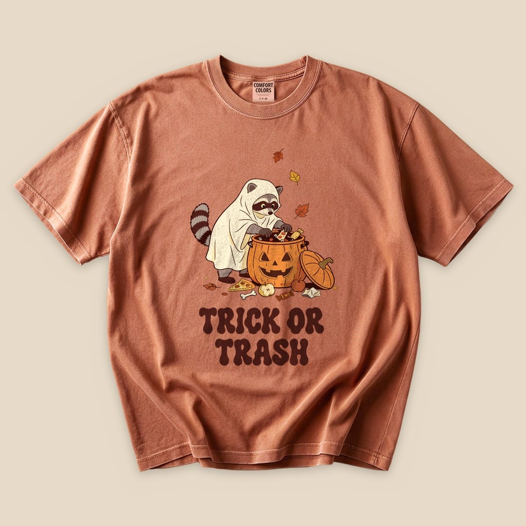 Yam Trick or Trash T-Shirt with a raccoon in a ghost costume raiding a pumpkin candy bucket graphic