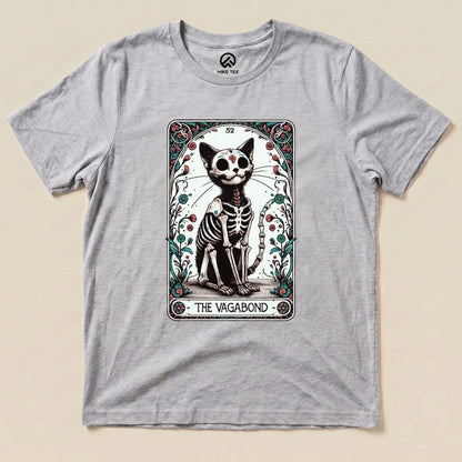 A graphic t-shirt featuring the "Vagabond Tarot Card Cat Shirt," showcasing a skeleton cat design within ornate borders.