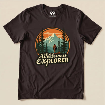 A graphic t-shirt featuring the "Wilderness Explorer Shirt" design with a hiker, mountains, and trees in vibrant colors.