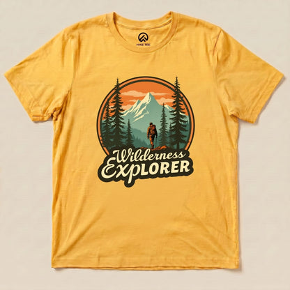 The graphic t-shirt features a "Wilderness Explorer Shirt" design with a hiker walking among trees and mountains in a vibrant sunset.