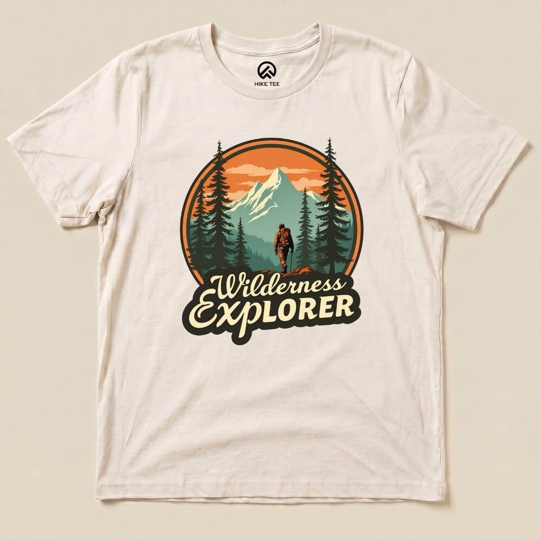 The Wilderness Explorer Shirt features a climber against a mountain backdrop with trees, highlighted in earthy tones.
