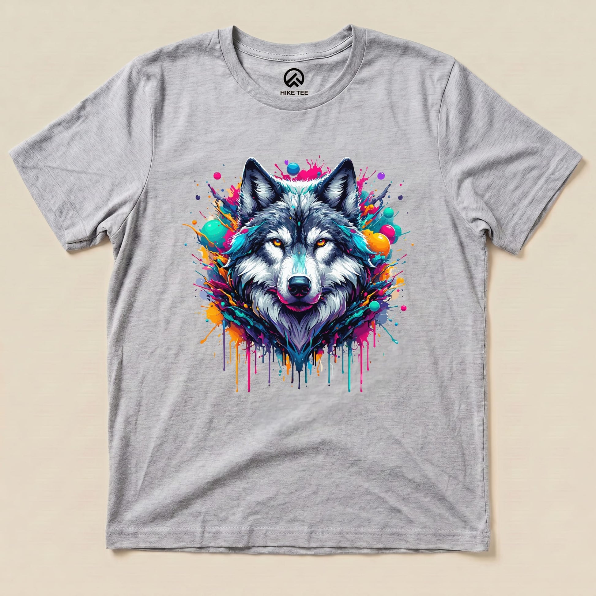 A graphic t-shirt featuring a vibrant, colorful wolf design surrounded by splashes of paint, labeled as the "Wolf Colorful Shirt.