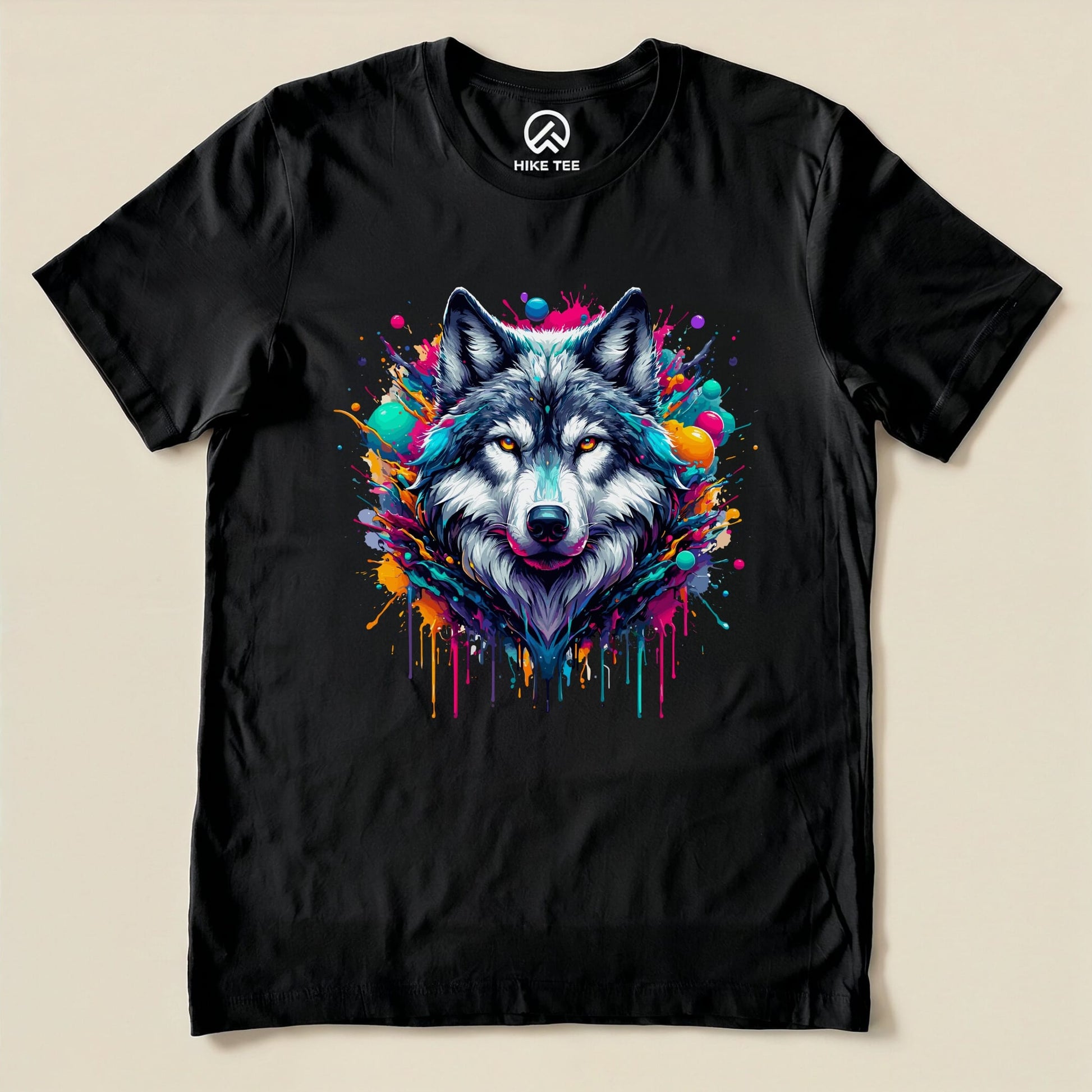 A black graphic t-shirt featuring a vibrant, colorful wolf design with splashes of paint surrounding its head, labeled "Wolf Colorful Shirt.
