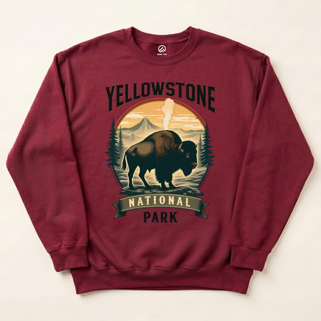 A maroon Yellowstone Bison Sweatshirt featuring a graphic of a bison with mountains, forests, and "Yellowstone National Park" text.