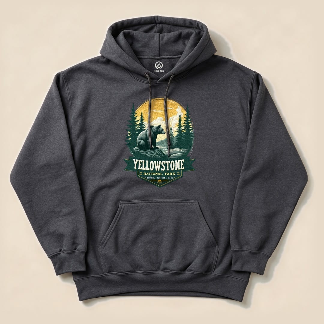 Gray hoodie featuring a Yellowstone Grizzly Bear graphic with a bear, pine trees, and a full moon backdrop.