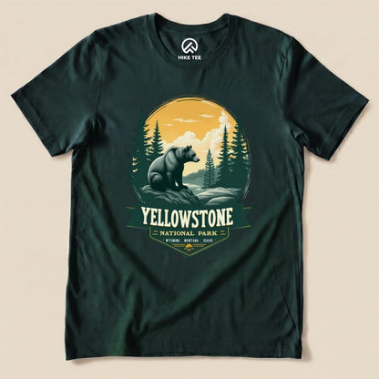 A graphic t-shirt featuring a Yellowstone Grizzly Bear Shirt design with a bear, trees, and a scenic backdrop in earthy colors.