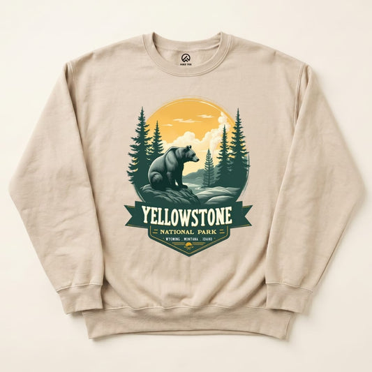 A beige Yellowstone Grizzly Bear Sweatshirt featuring a graphic of a bear against a scenic backdrop with trees and mountains.