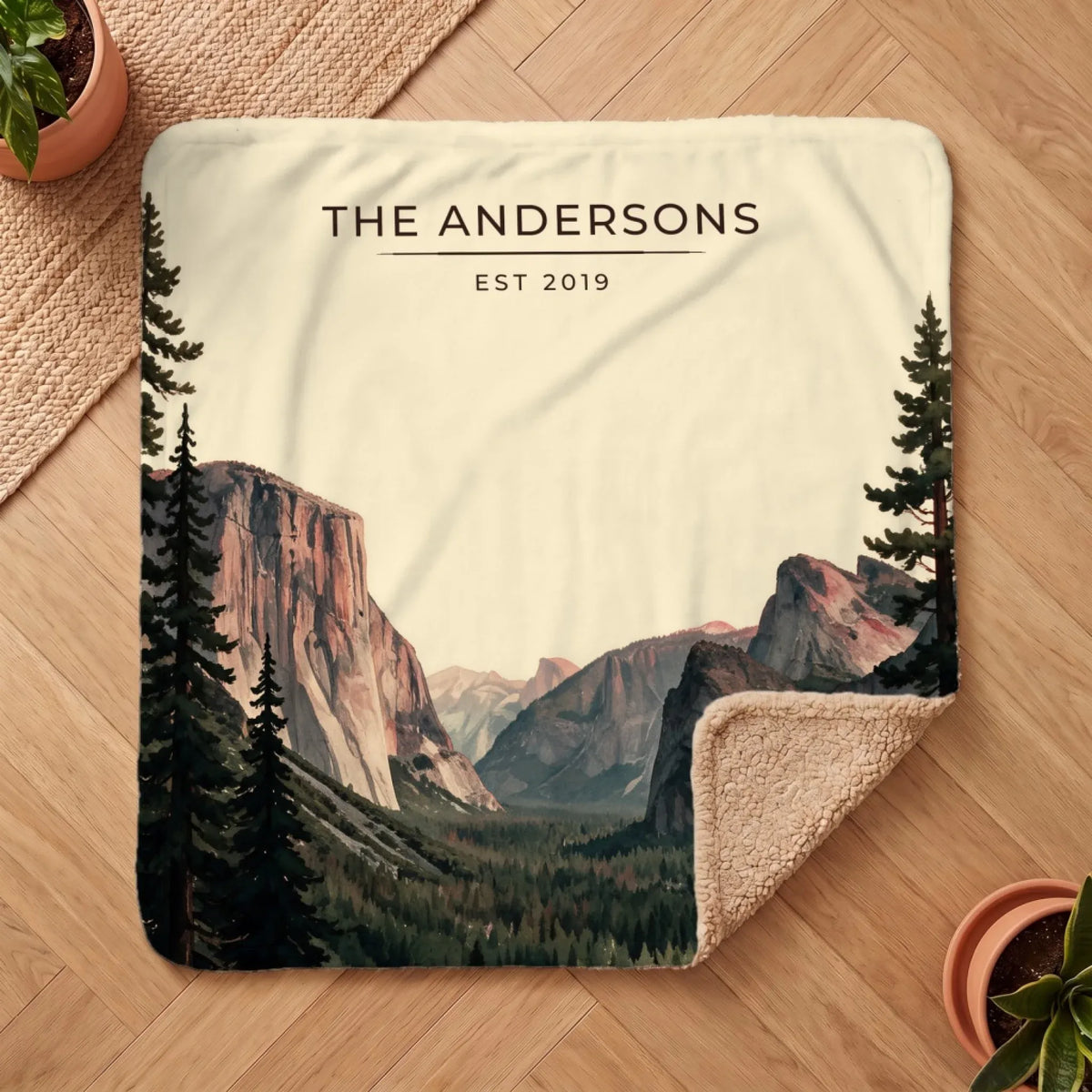 Personalized Yosemite Tunnel View Sherpa Blanket on a wooden floor with the cozy sherpa back showing