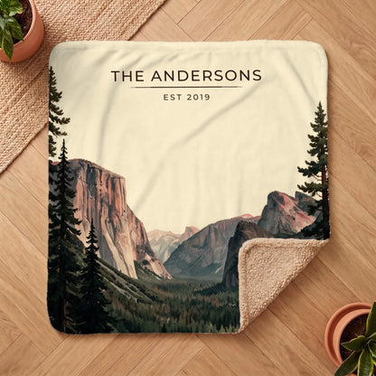 Personalized Yosemite Tunnel View Sherpa Blanket on a wooden floor with the cozy sherpa back showing