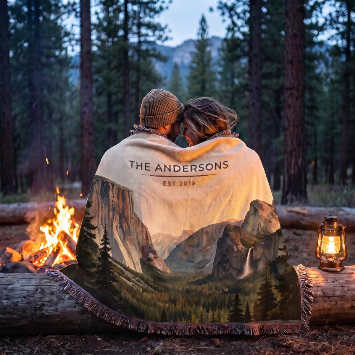Couple wrapped in the Yosemite Tunnel View Woven Blanket by a campfire