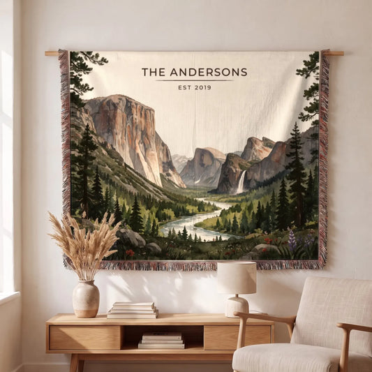 A beautifully crafted "Yosemite Valley Woven Blanket" featuring a scenic landscape of mountains and a river, personalized with "The Andersons.