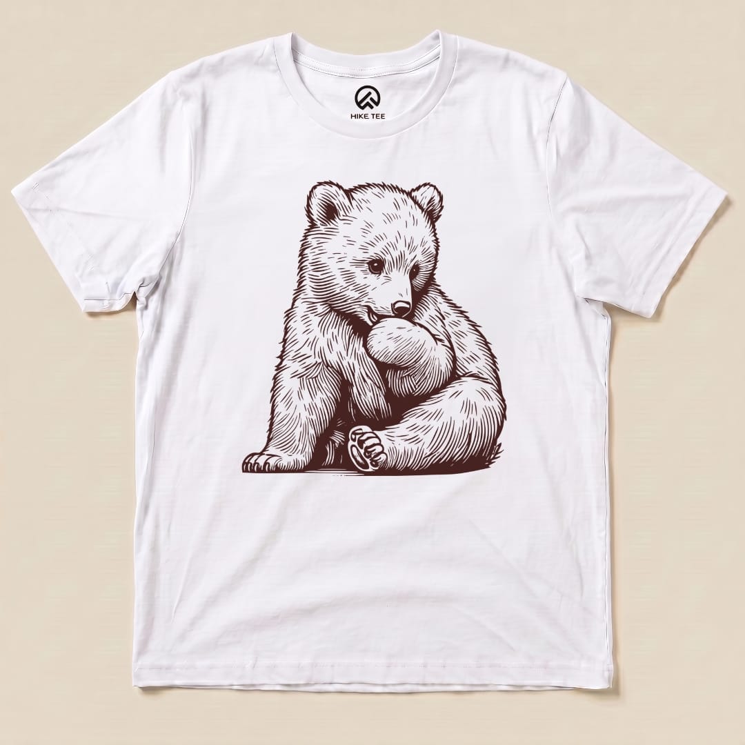 A graphic t-shirt featuring a playful bear illustration, titled "Youth Bear Shirt," on a white background.