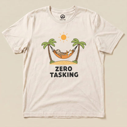 A graphic t-shirt featuring a sloth and a cat lounging in a hammock under palm trees, with the words "ZERO TASKING" displayed prominently.
