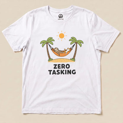 A graphic t-shirt featuring a sloth and a cat lounging in a hammock under palm trees with the slogan "ZERO TASKING.