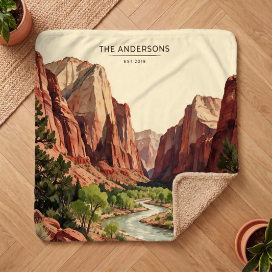 Cozy Zion Canyon River Sherpa Blanket with a scenic mountain and river design, showcasing red cliffs and lush greenery.