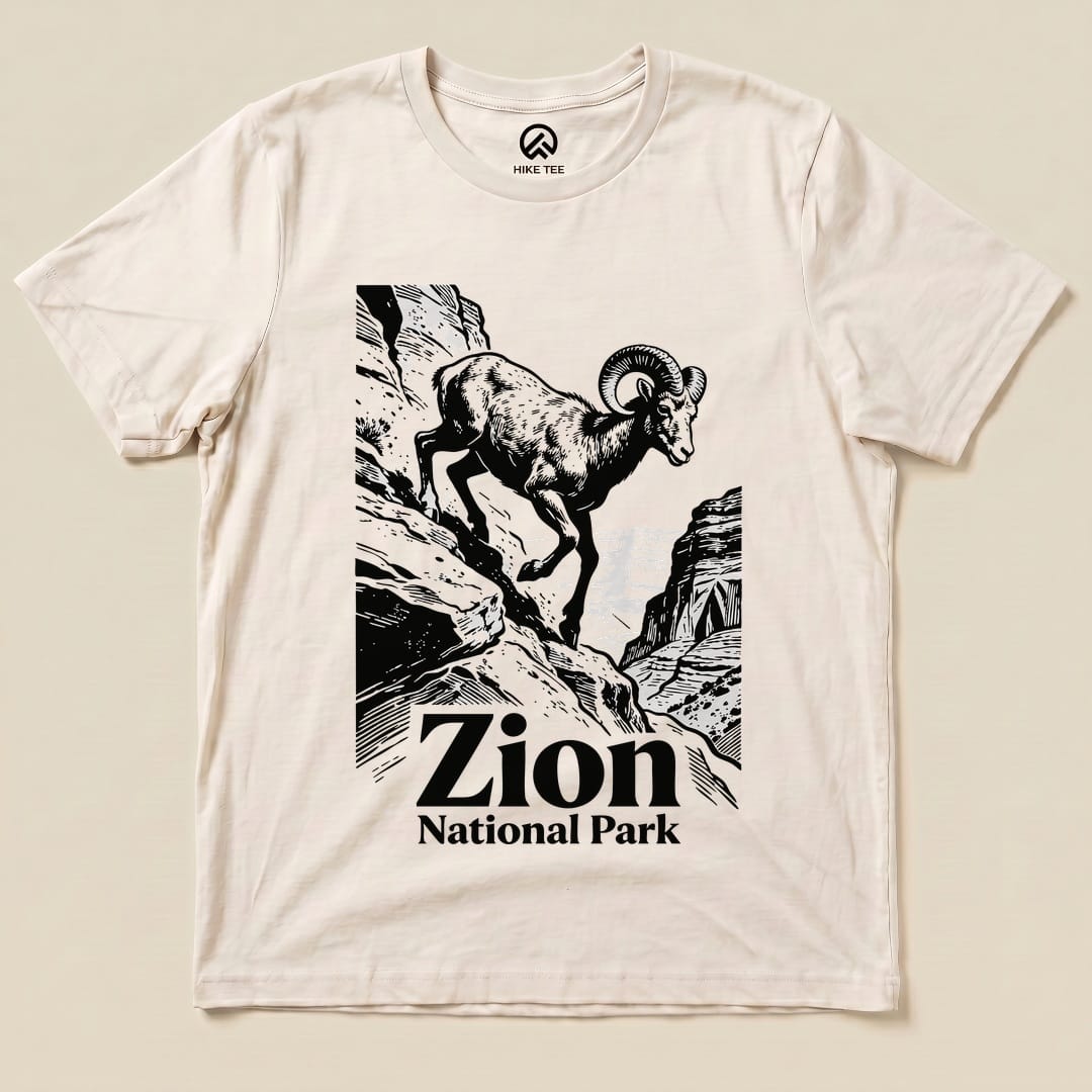 A graphic t-shirt featuring a mountain goat and the words "Zion National Park" printed prominently below the illustration.