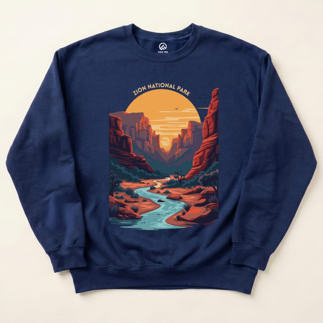 A navy blue Zion National Park Sweatshirt featuring a vibrant graphic of a canyon landscape with a river at sunset.